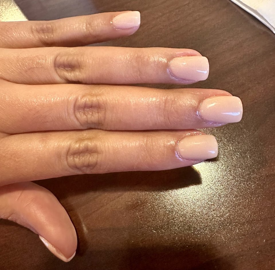 Manicured nails in a nail salon setting.